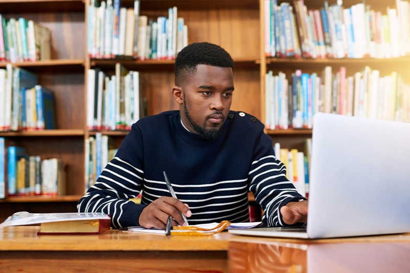 teenager boy studying with computer